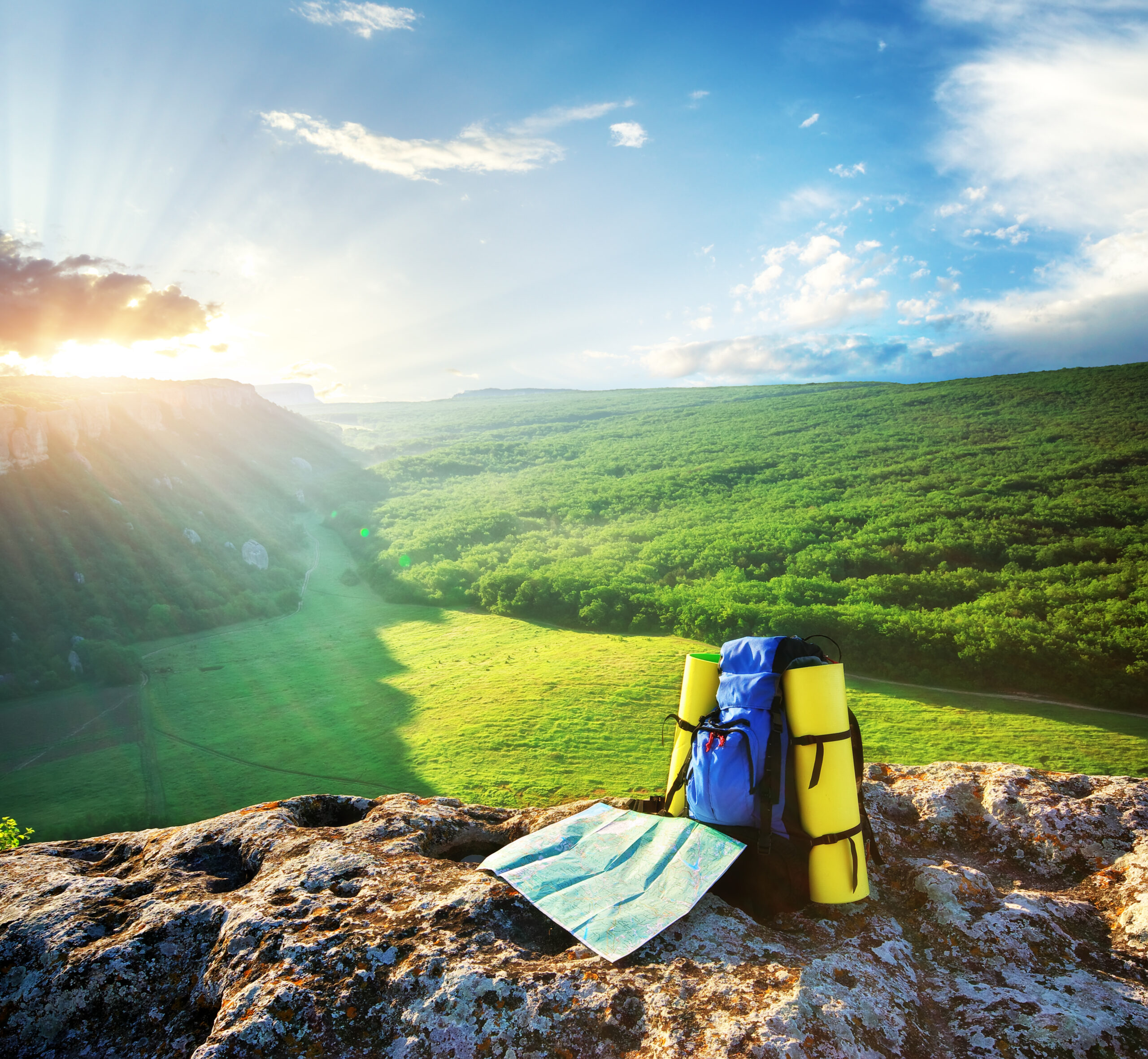 Backpack and map in mountain.